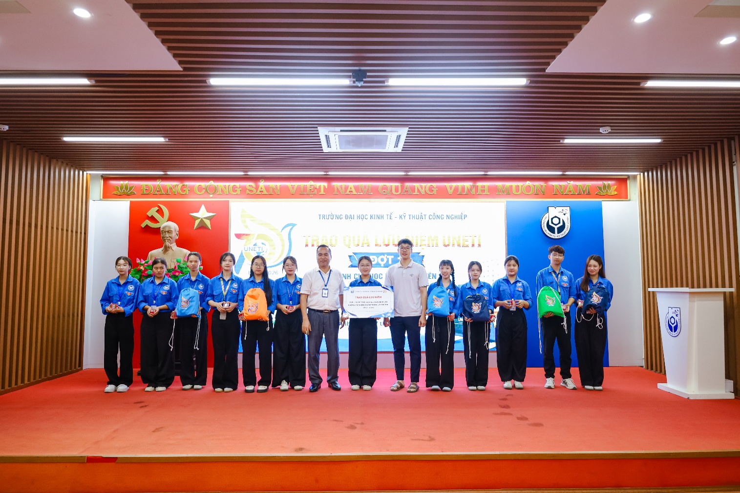 A group of people standing on a stage
Description automatically generated