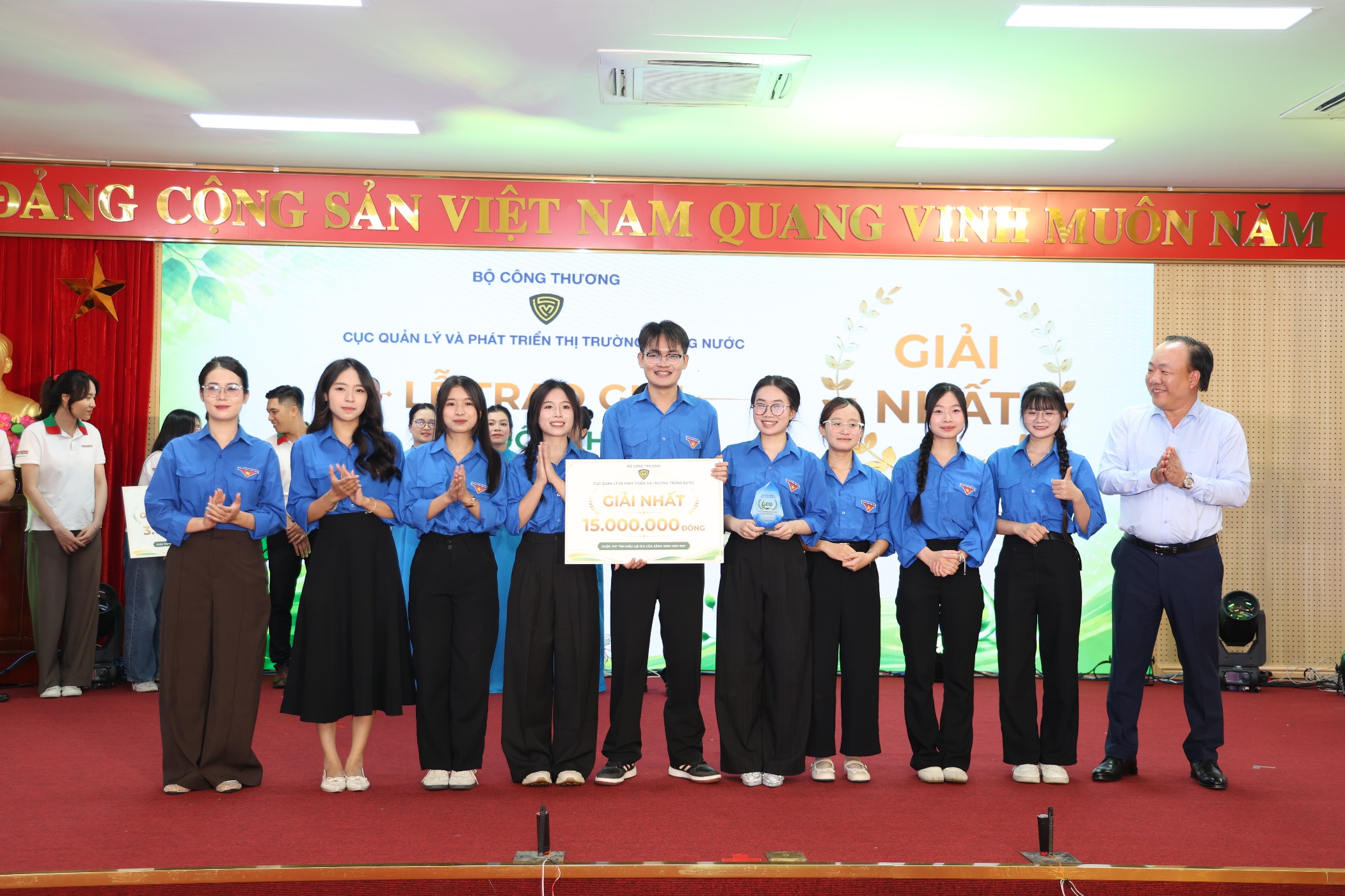 A group of people standing on a stage Description automatically generated