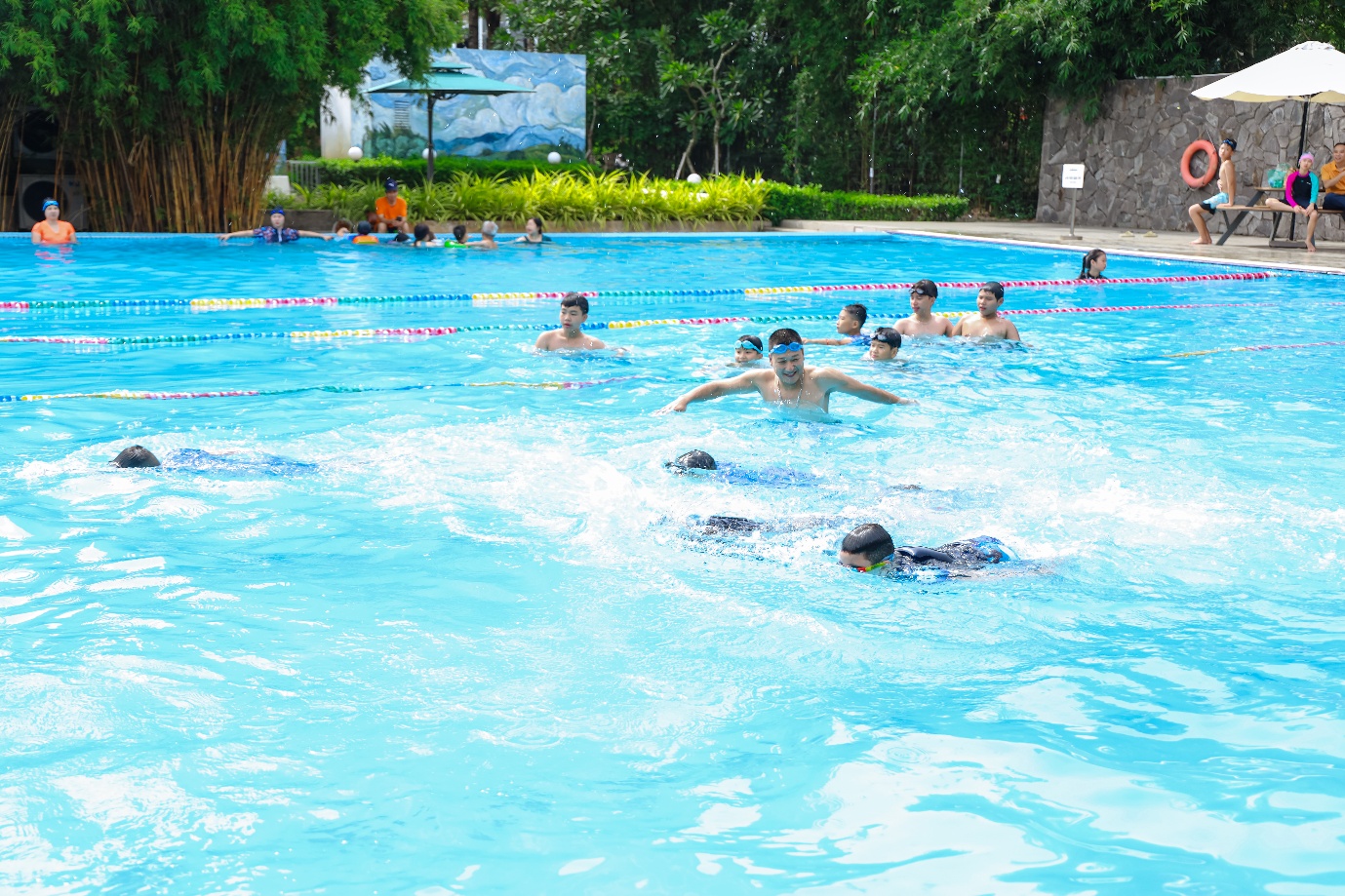 A group of people swimming in a pool Description automatically generated