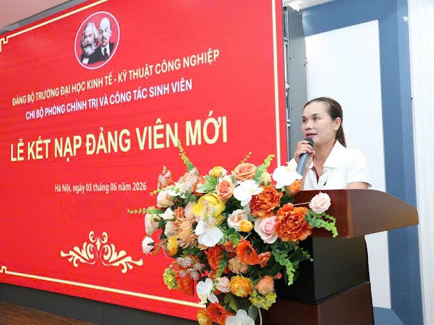 A person speaking into a microphone at a podium with flowers
Description automatically generated