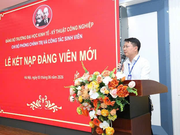 A person standing at a podium with a microphone
Description automatically generated