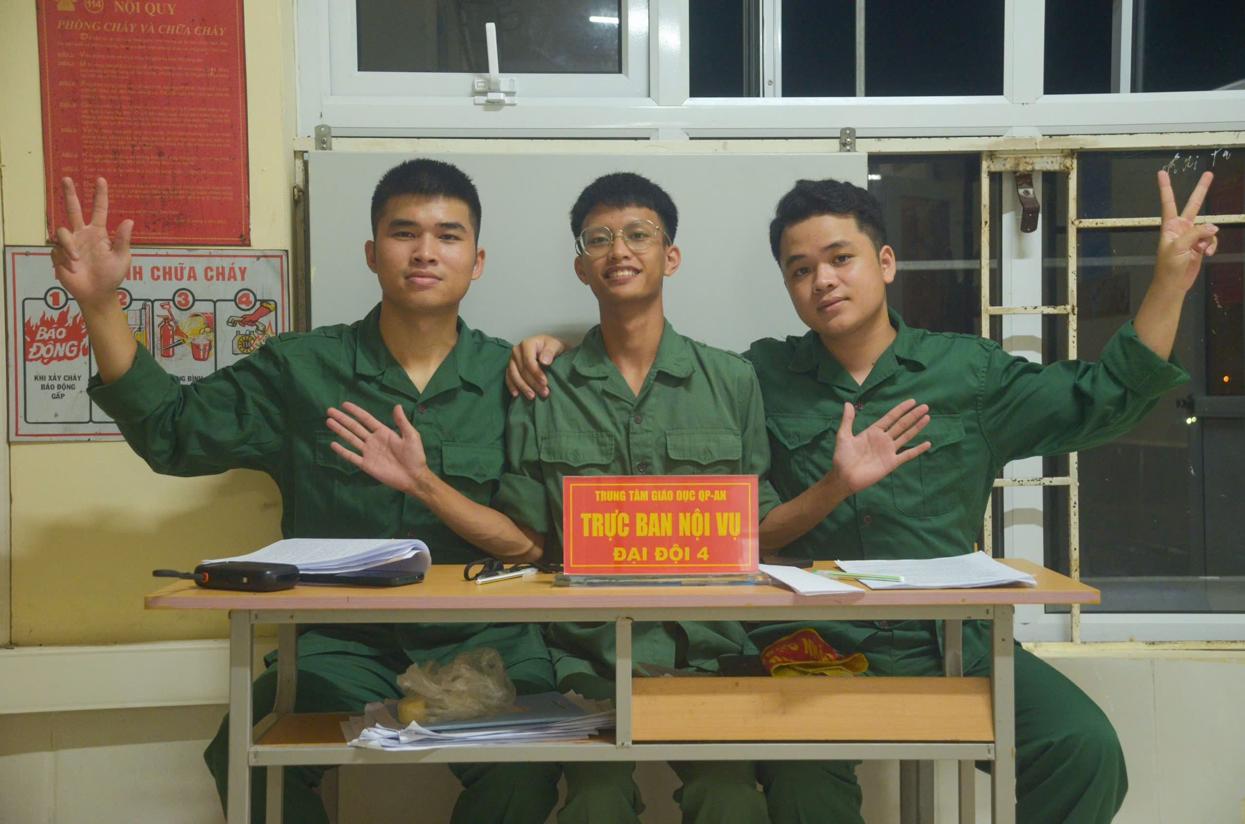 A group of young men in green uniforms Description automatically generated